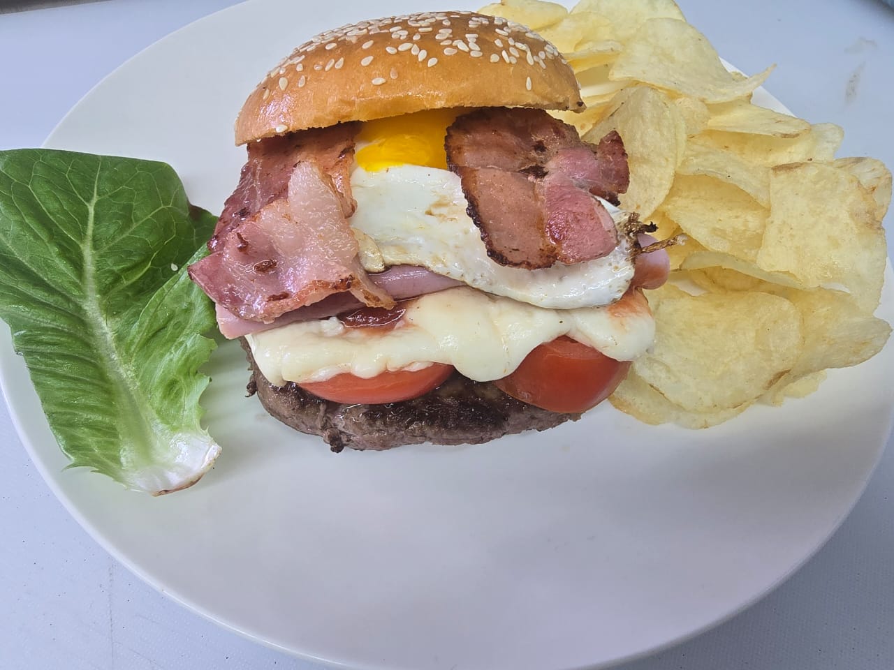 Super Full Burger with ham mozzarella cheese egg and bacon with chips